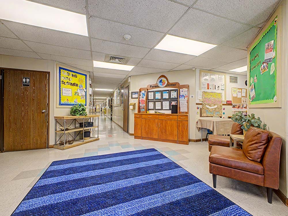 Hallway in an education building with a parent center and lounge chairs