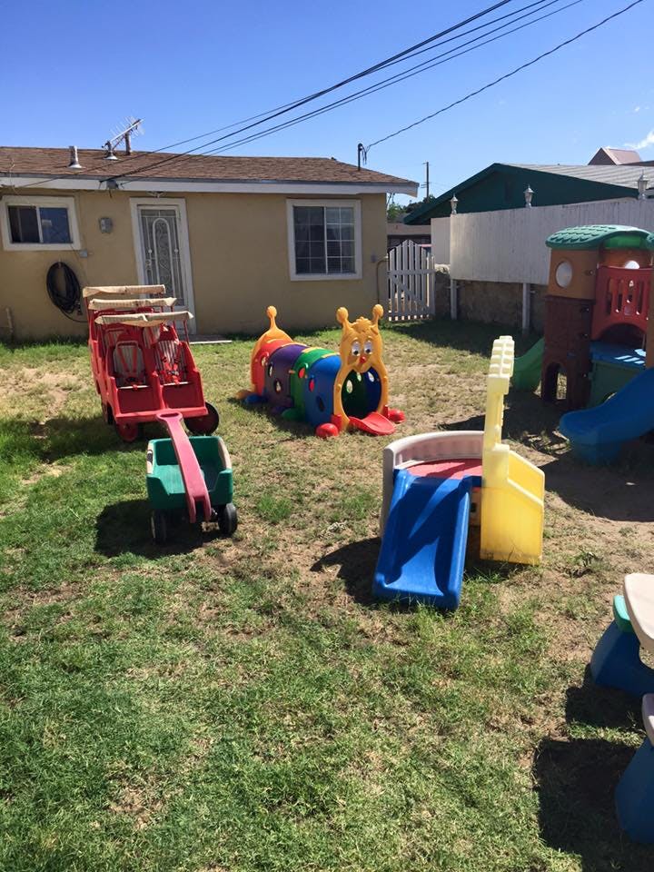 Playground with a red wagon, caterpillar tunnel, and blue slide