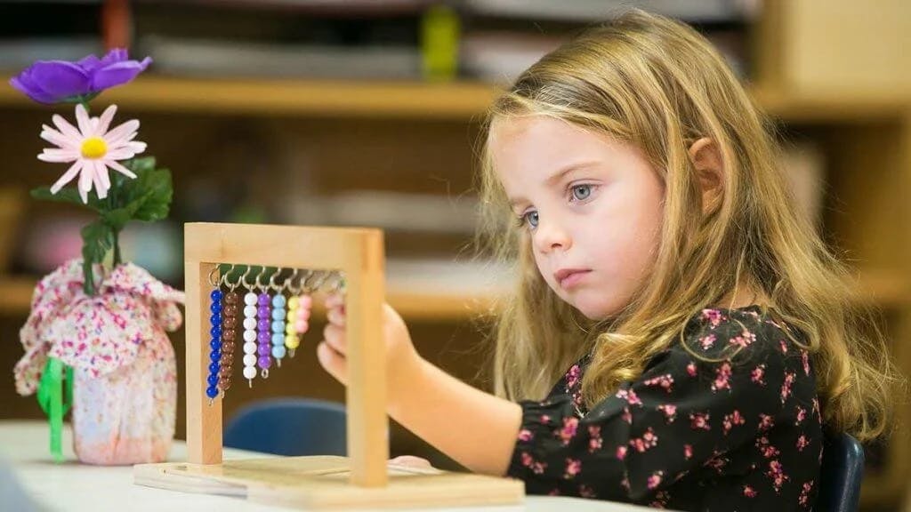Child learning to count with an abacus