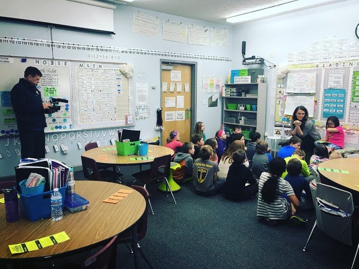 Adults and children in a classroom