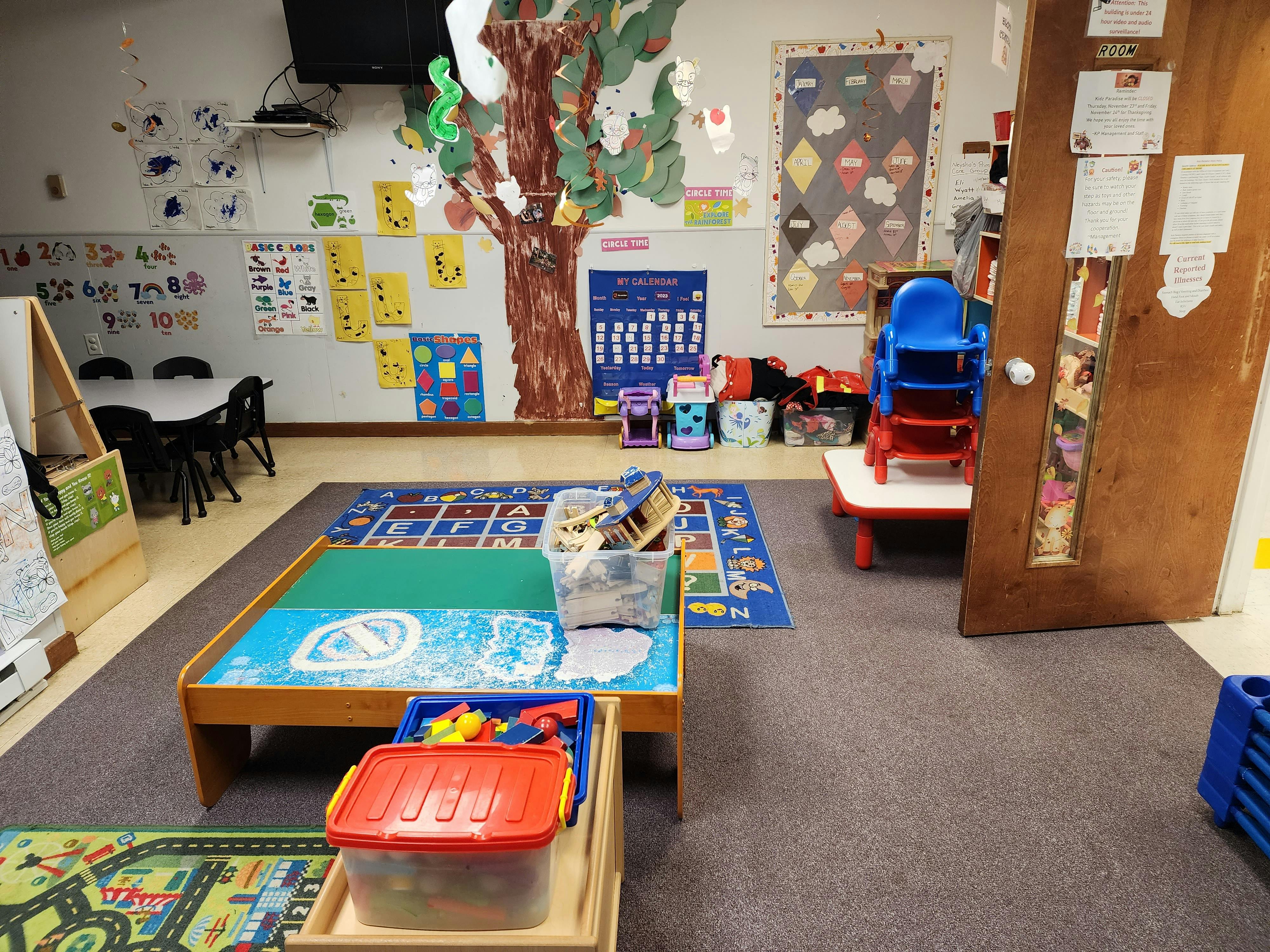 Colorful classroom with an alphabet rug and calendar on the wall