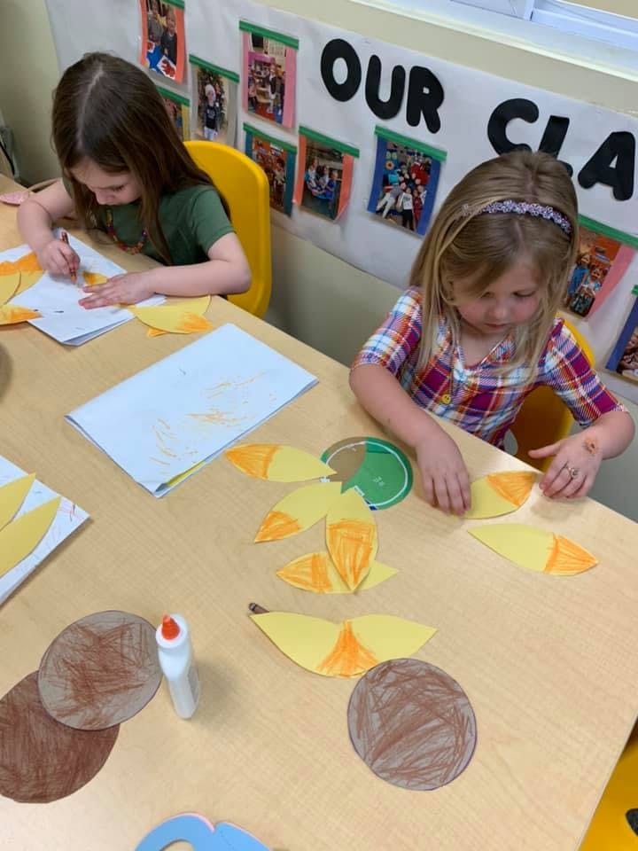 Two children doing crafts at a table