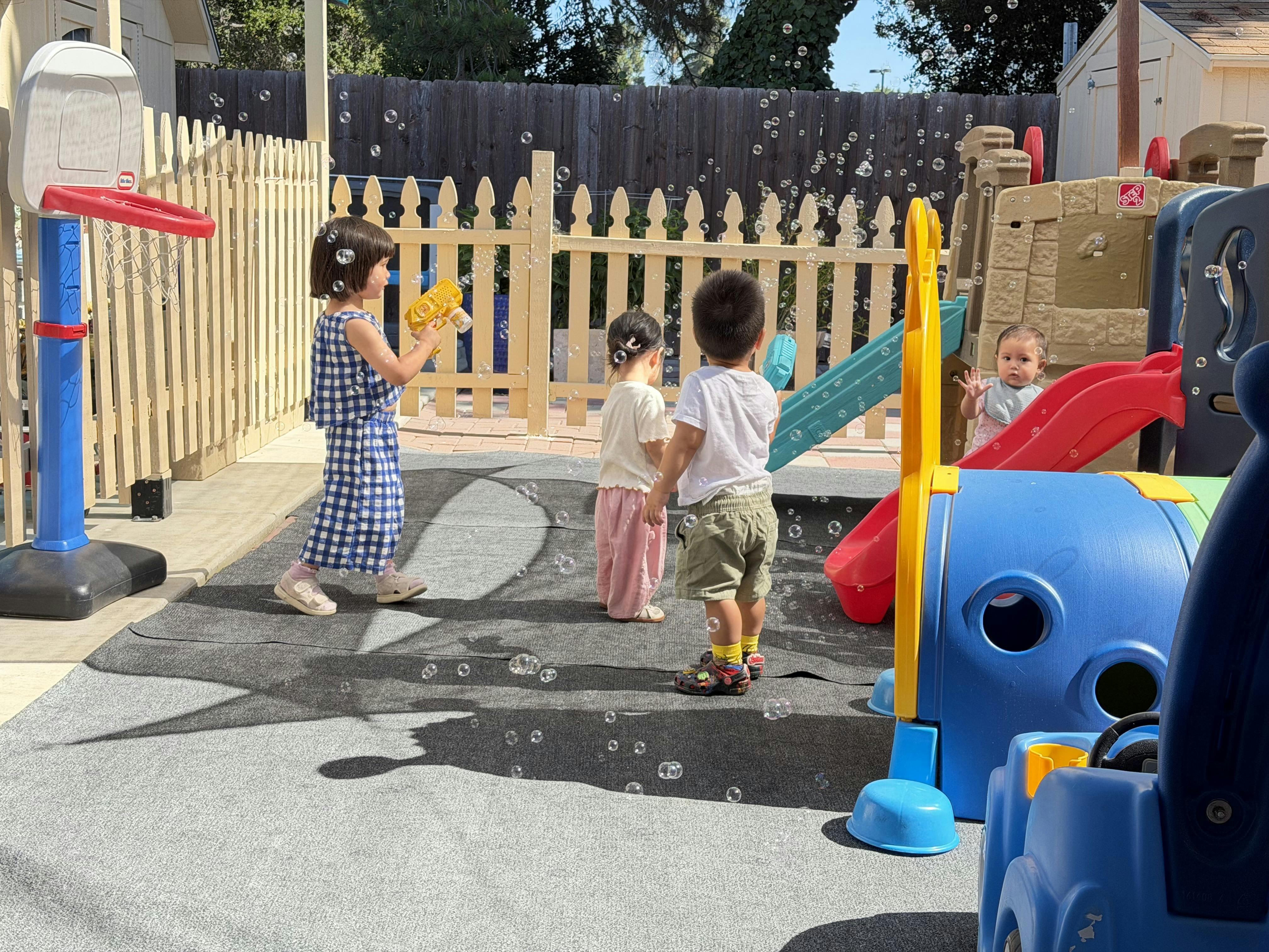 Children playing with bubble wands in a playground