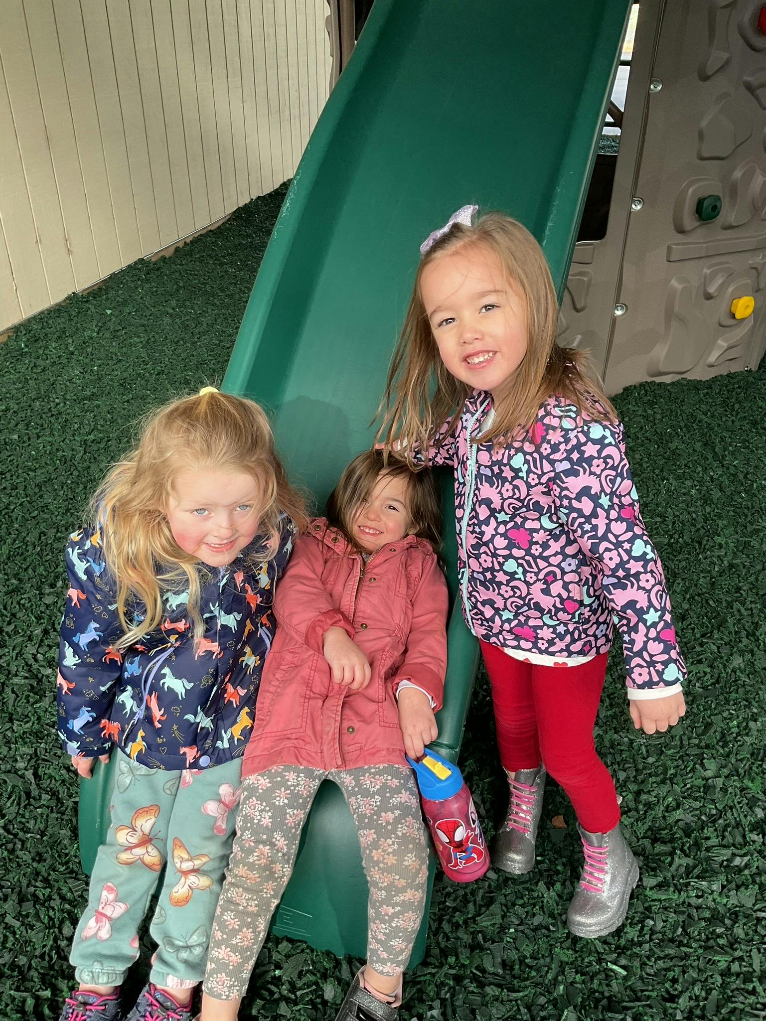 Three children on a playground slide