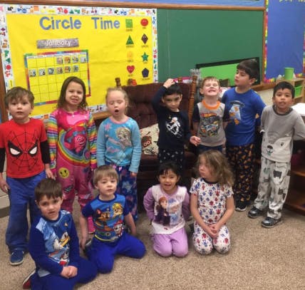 Group of children in pajamas in a classroom