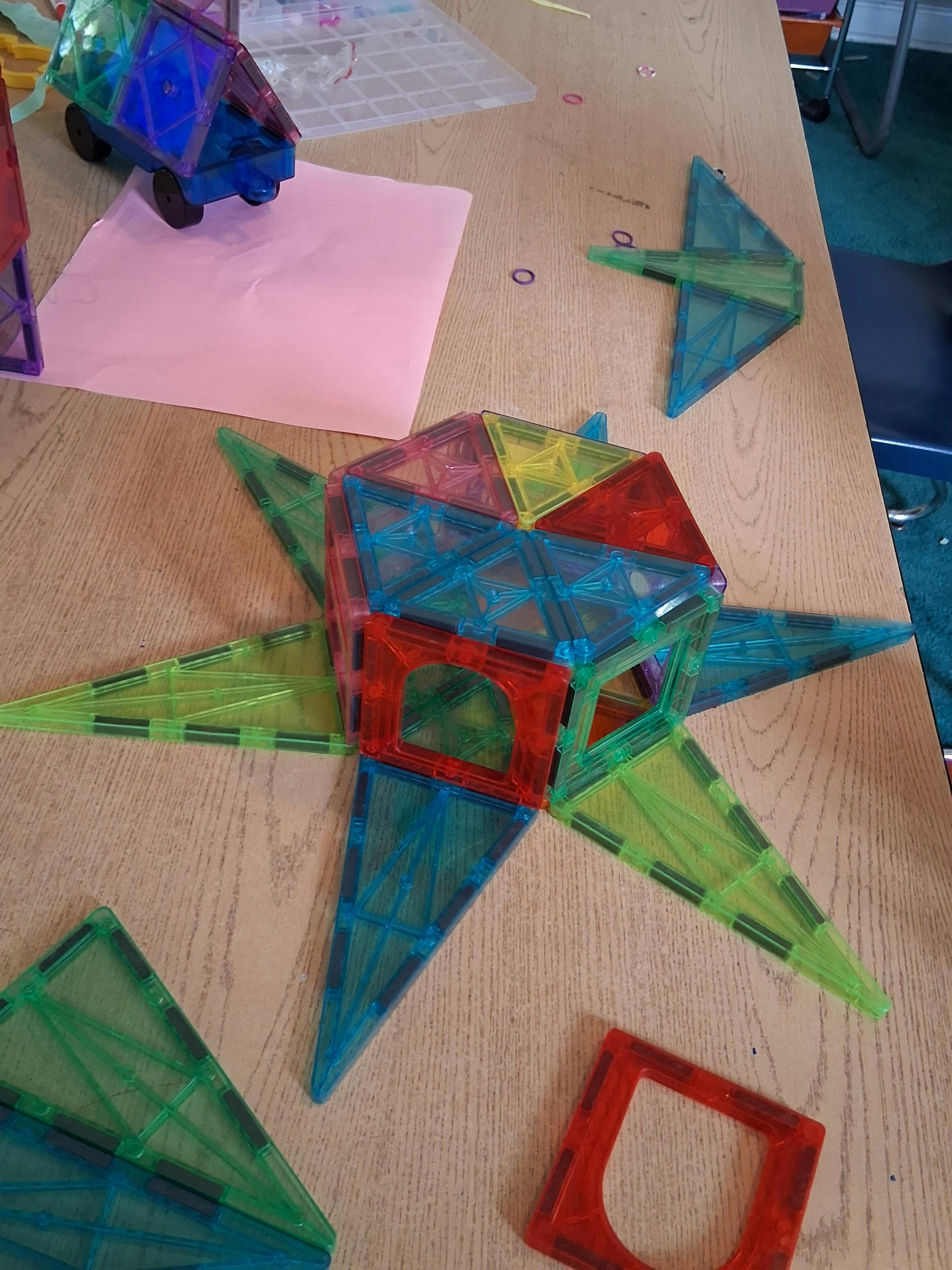 Multicolor magnetic tile construction on a wooden surface