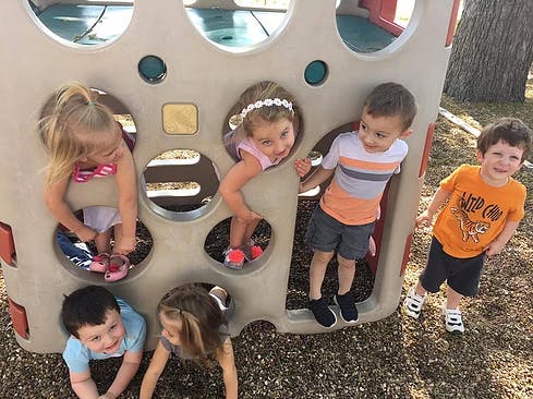 Children playing on a playground structure