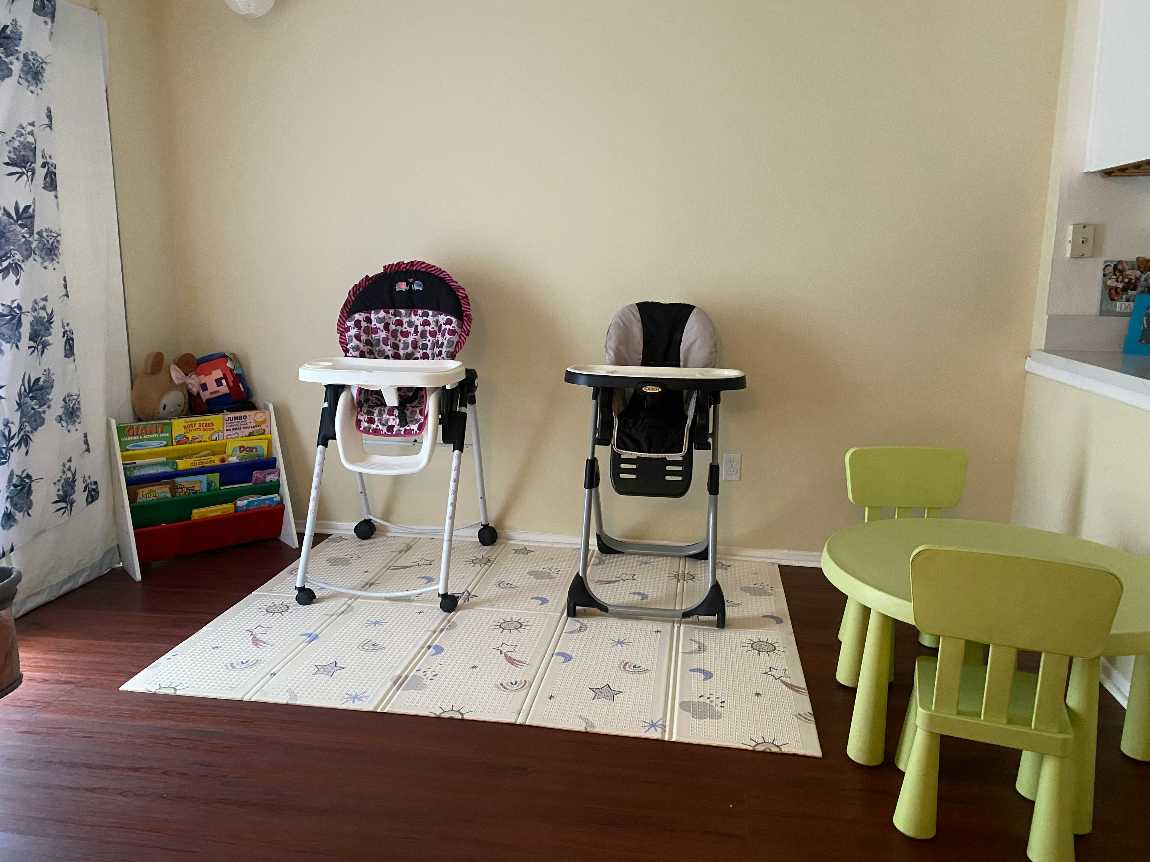 Two high chairs and a small table with chairs in a room