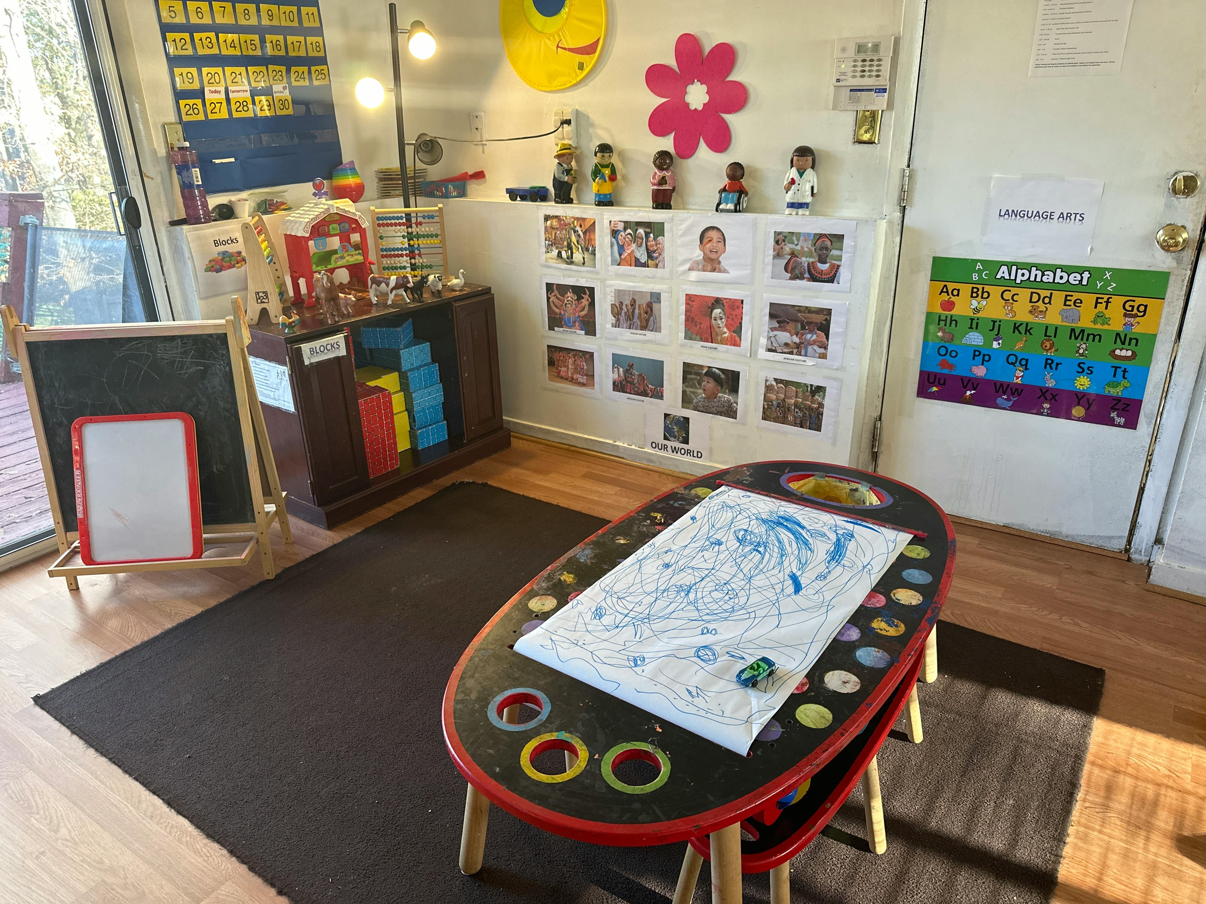 Child's art table with paper and crayons in a classroom