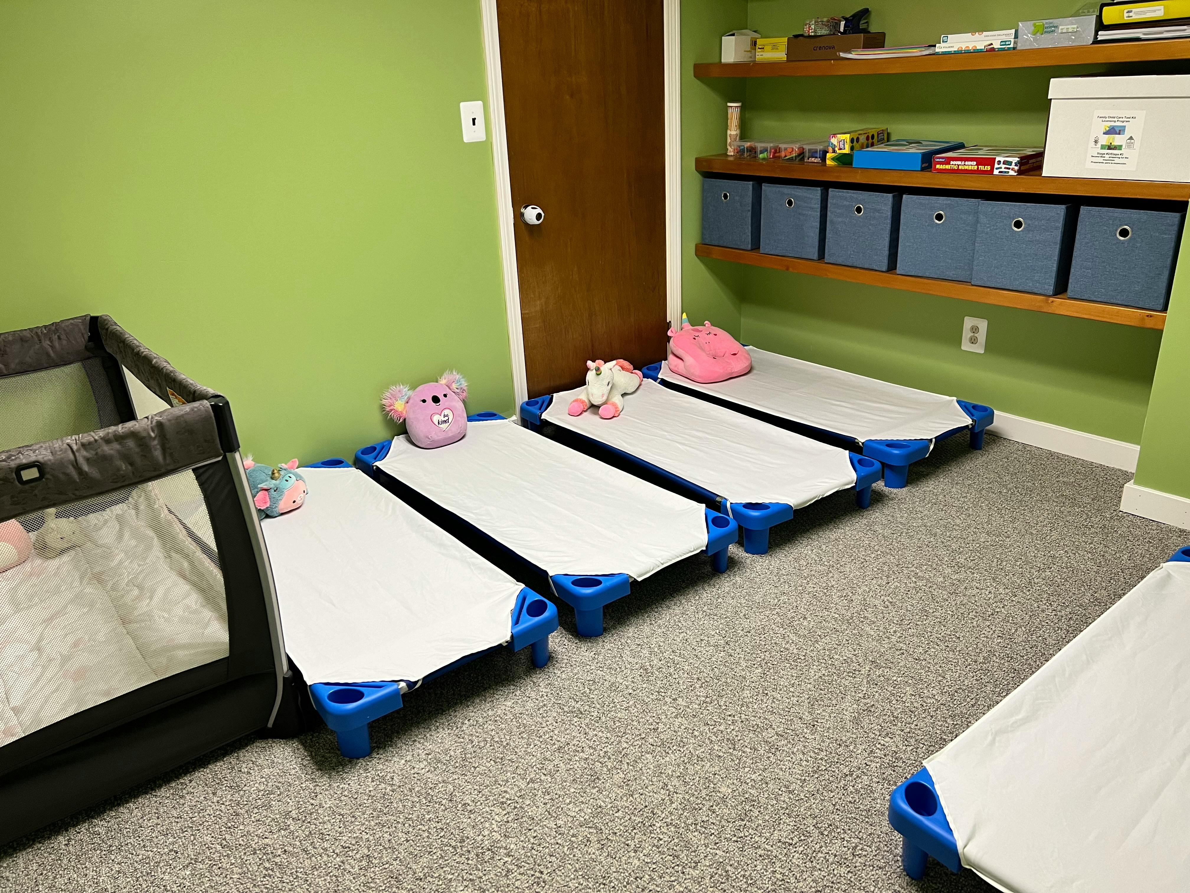 Child cots and a crib in a room
