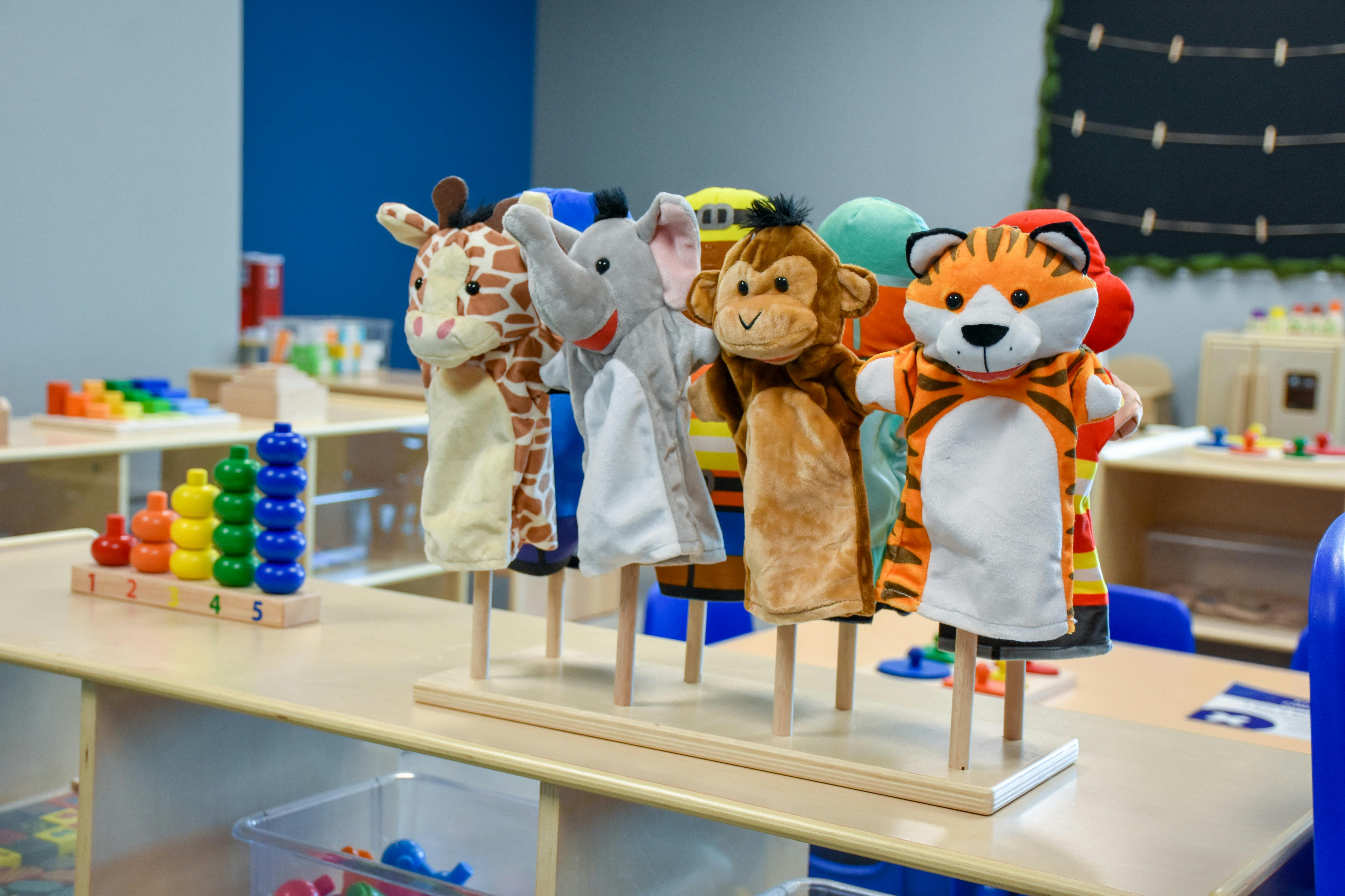 Animal hand puppets on display in a classroom