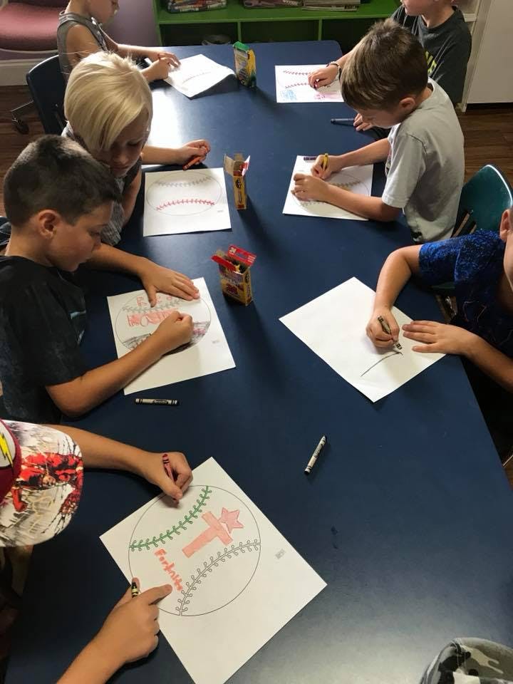 Children coloring at a table