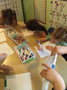 Children drawing at a table