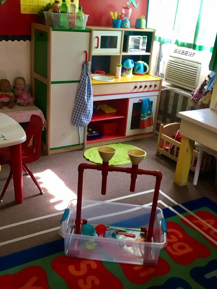 Play kitchen and water play station in a classroom