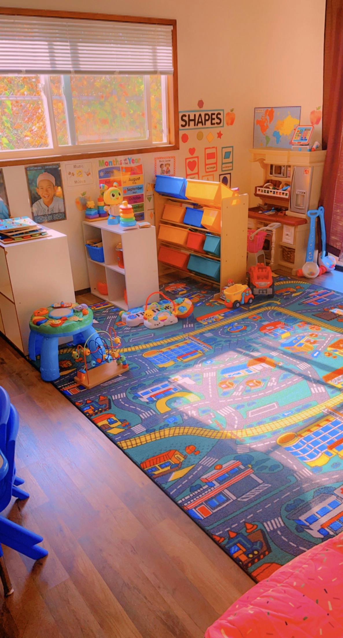 Playroom with a road map rug and various toys