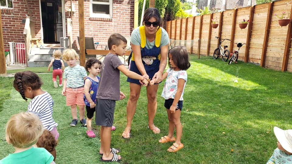 Adult and children playing outdoors