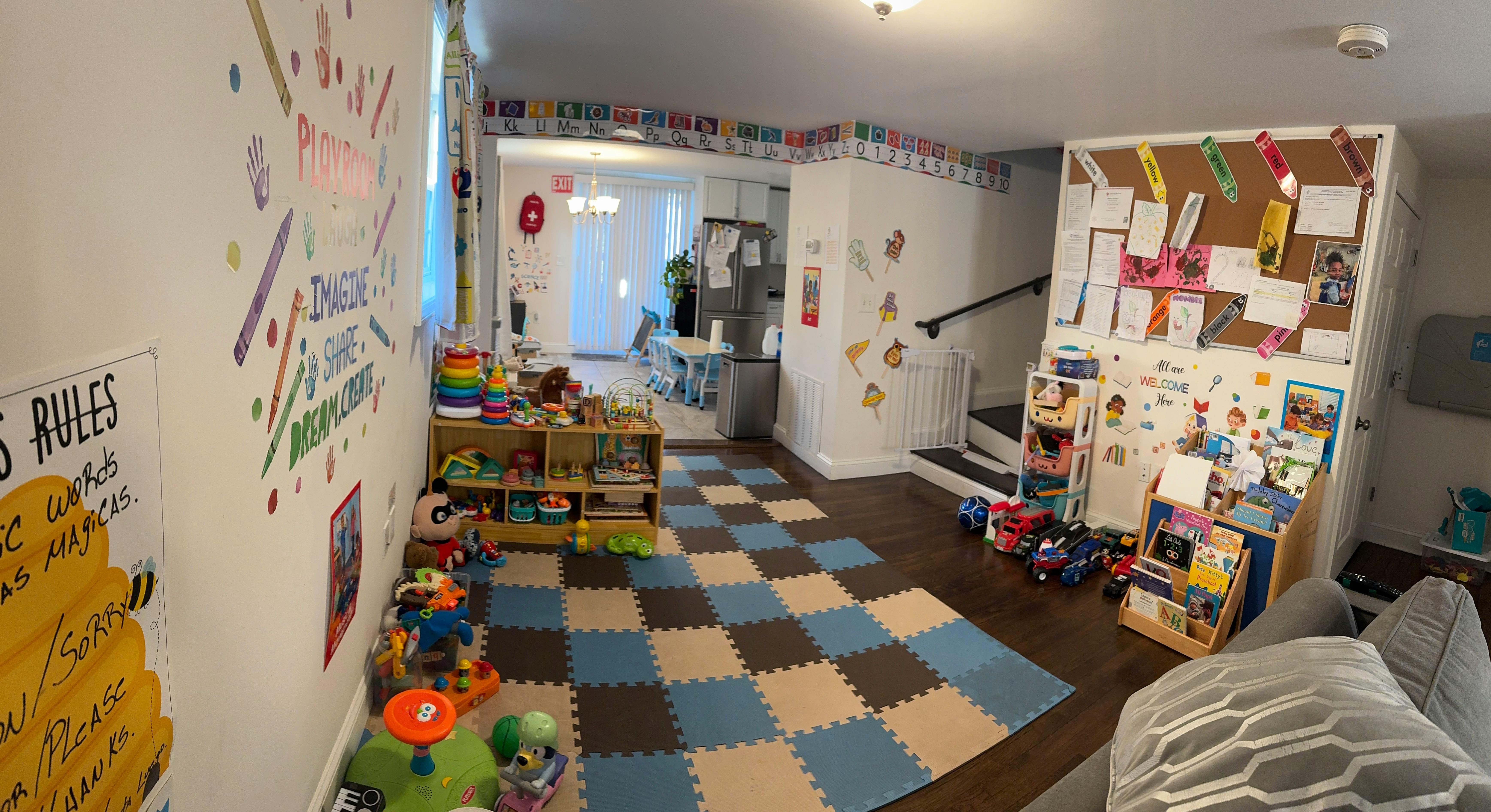 Playroom with checkered floor mats, toys, and bulletin boards