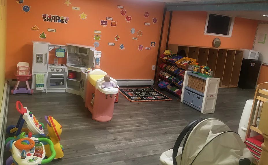 Playroom with toys, play kitchen, and storage shelves