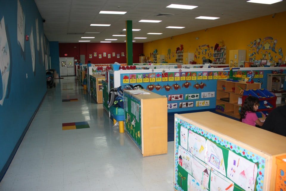 Classroom with colorful walls and dividers displaying children's artwork