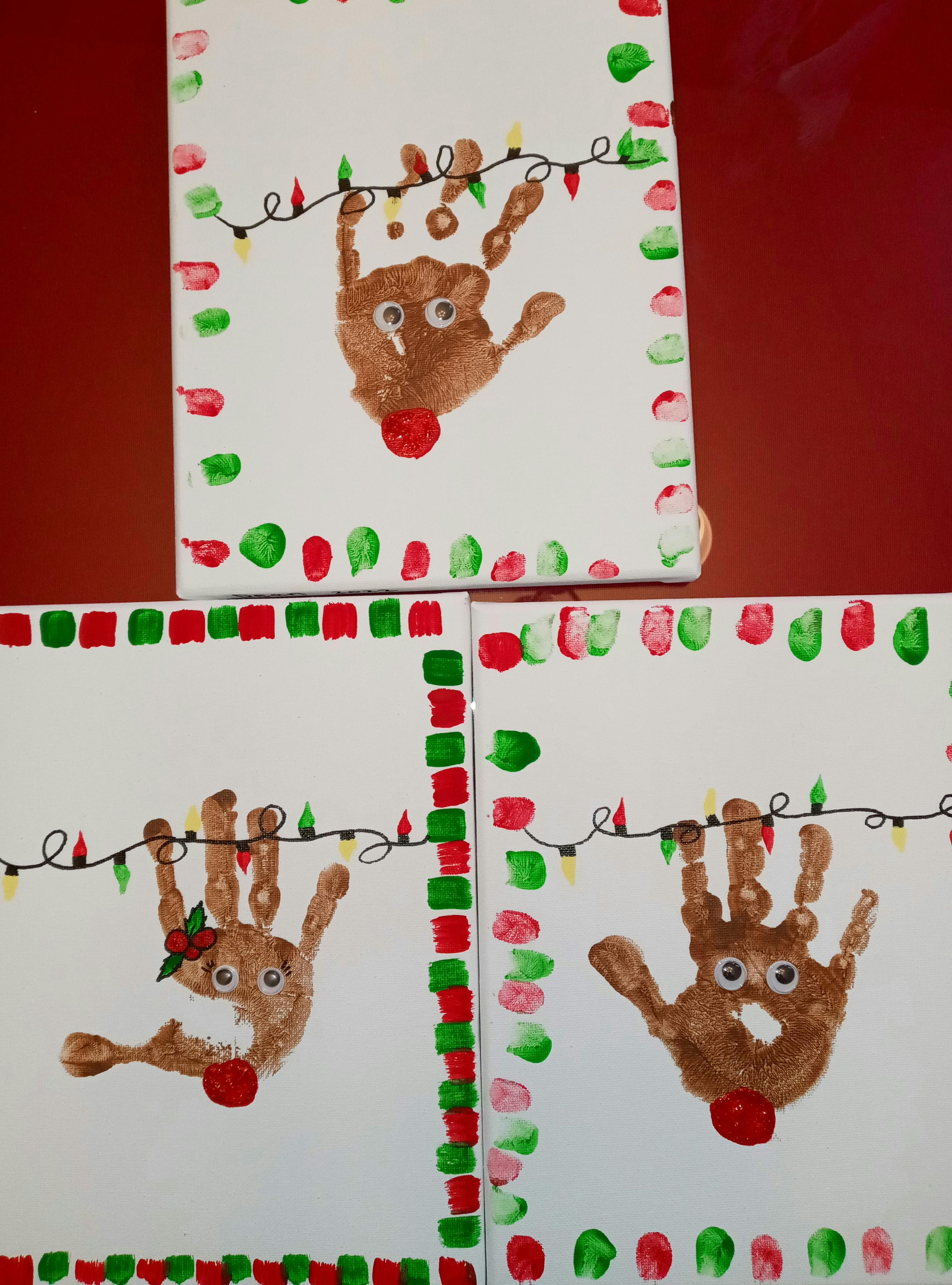 Three handprint reindeer crafts with string lights and painted borders