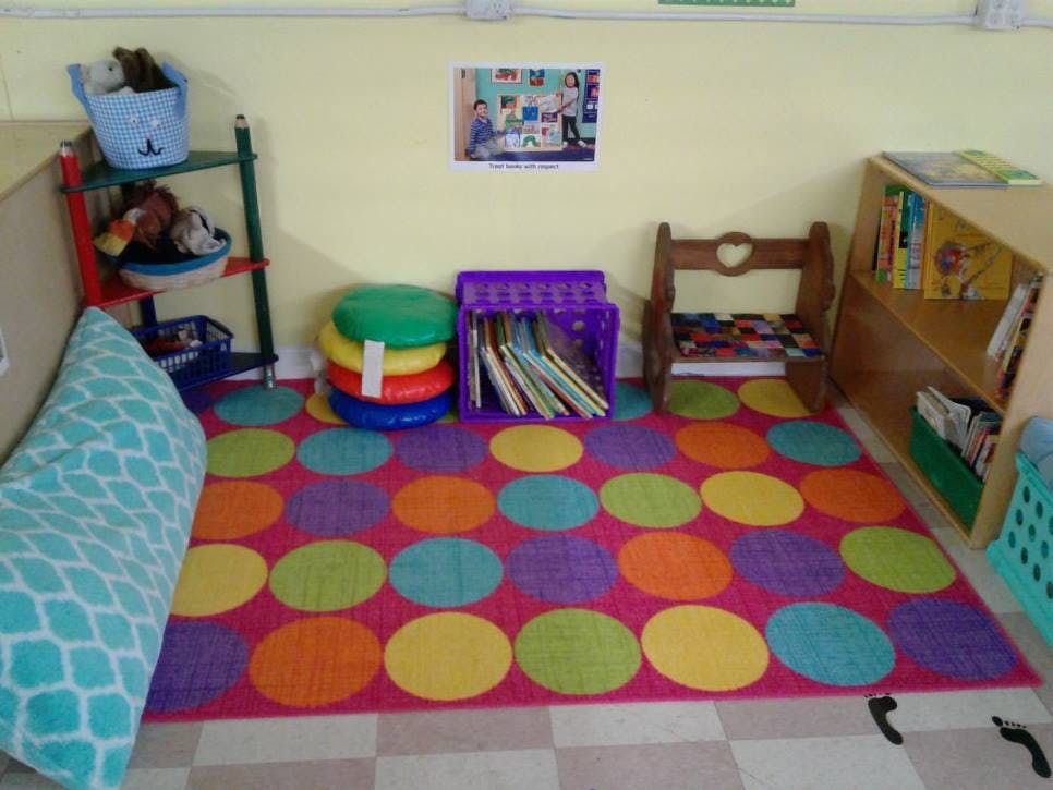 Colorful rug with polka dots in a classroom reading corner