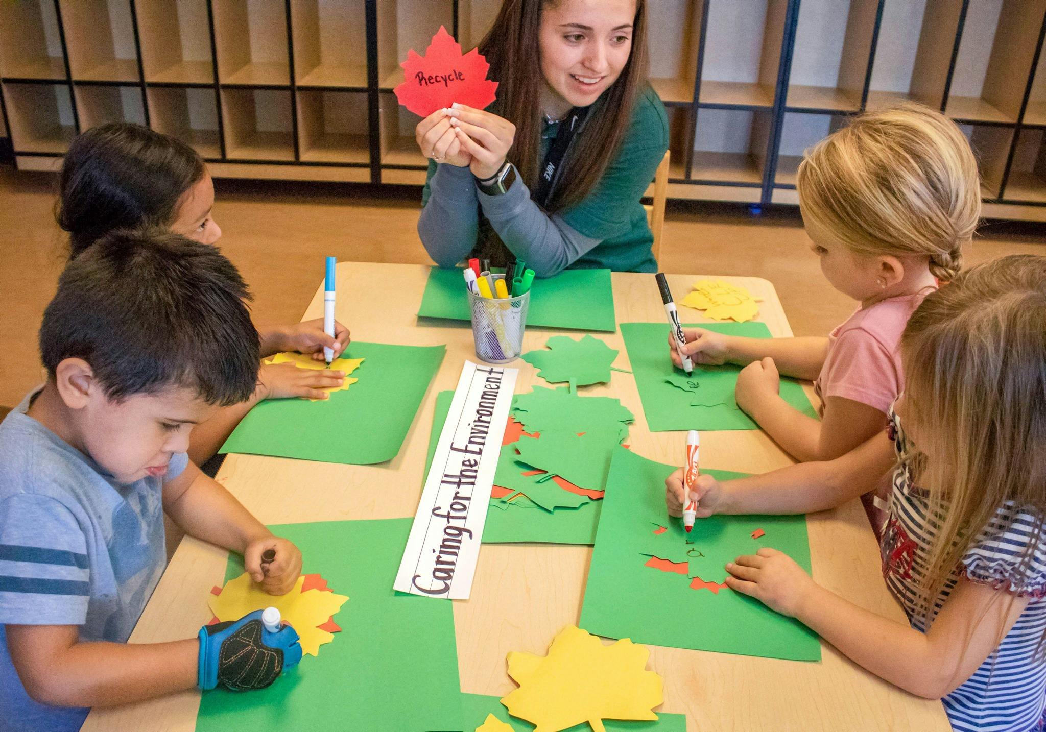 Adult and children doing crafts at a table