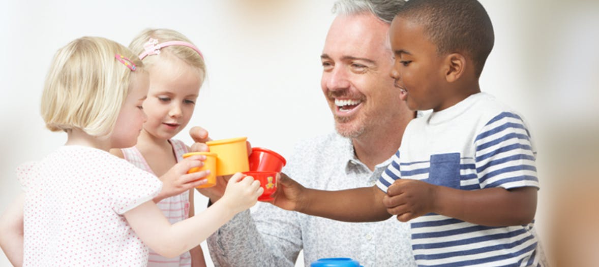 Adult and three children holding colorful cups