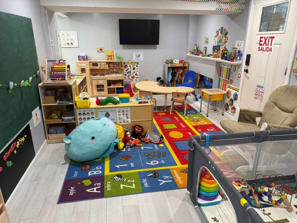 Classroom interior with educational toys and alphabet rug