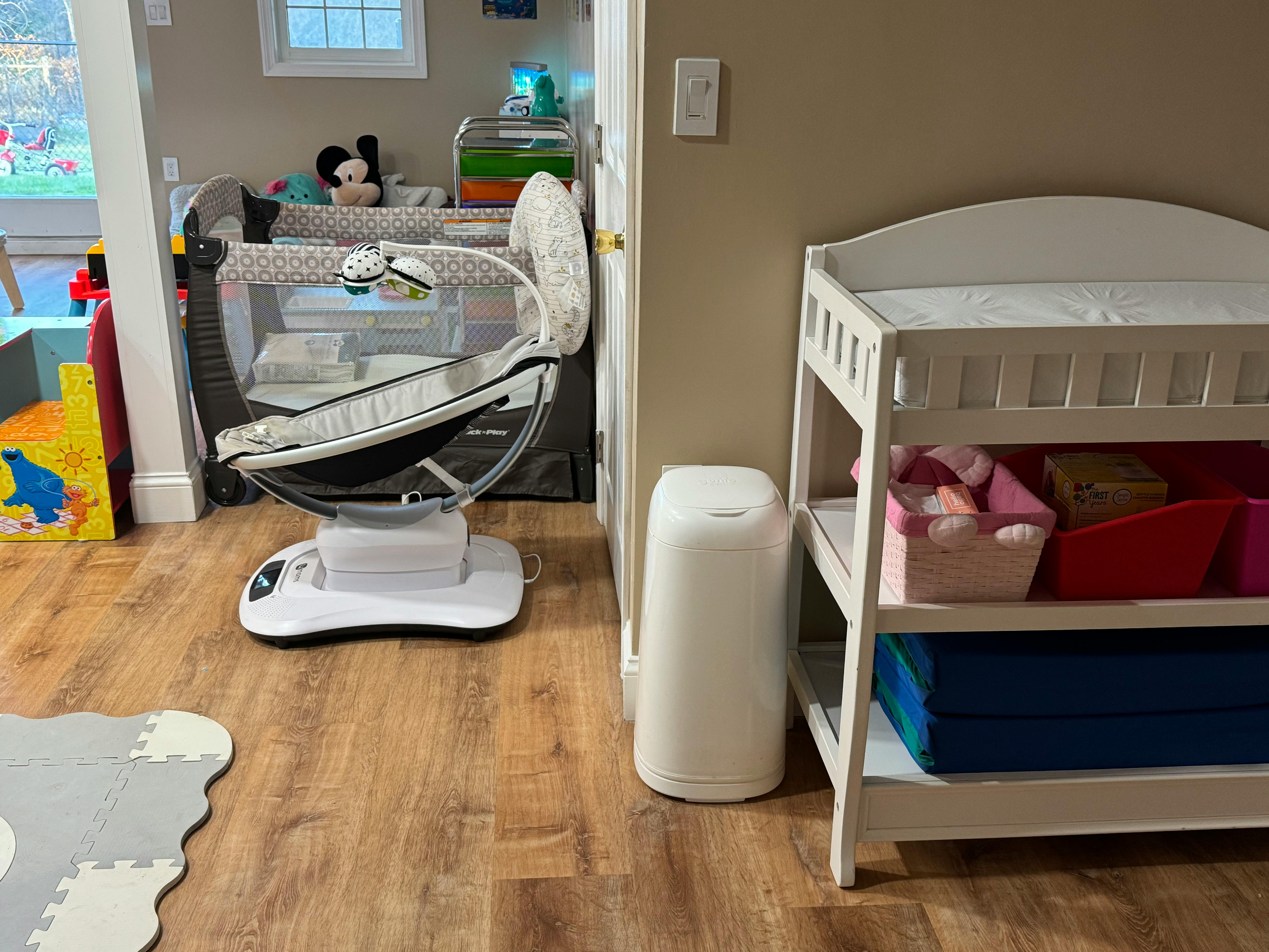 Baby swing and changing table in a room
