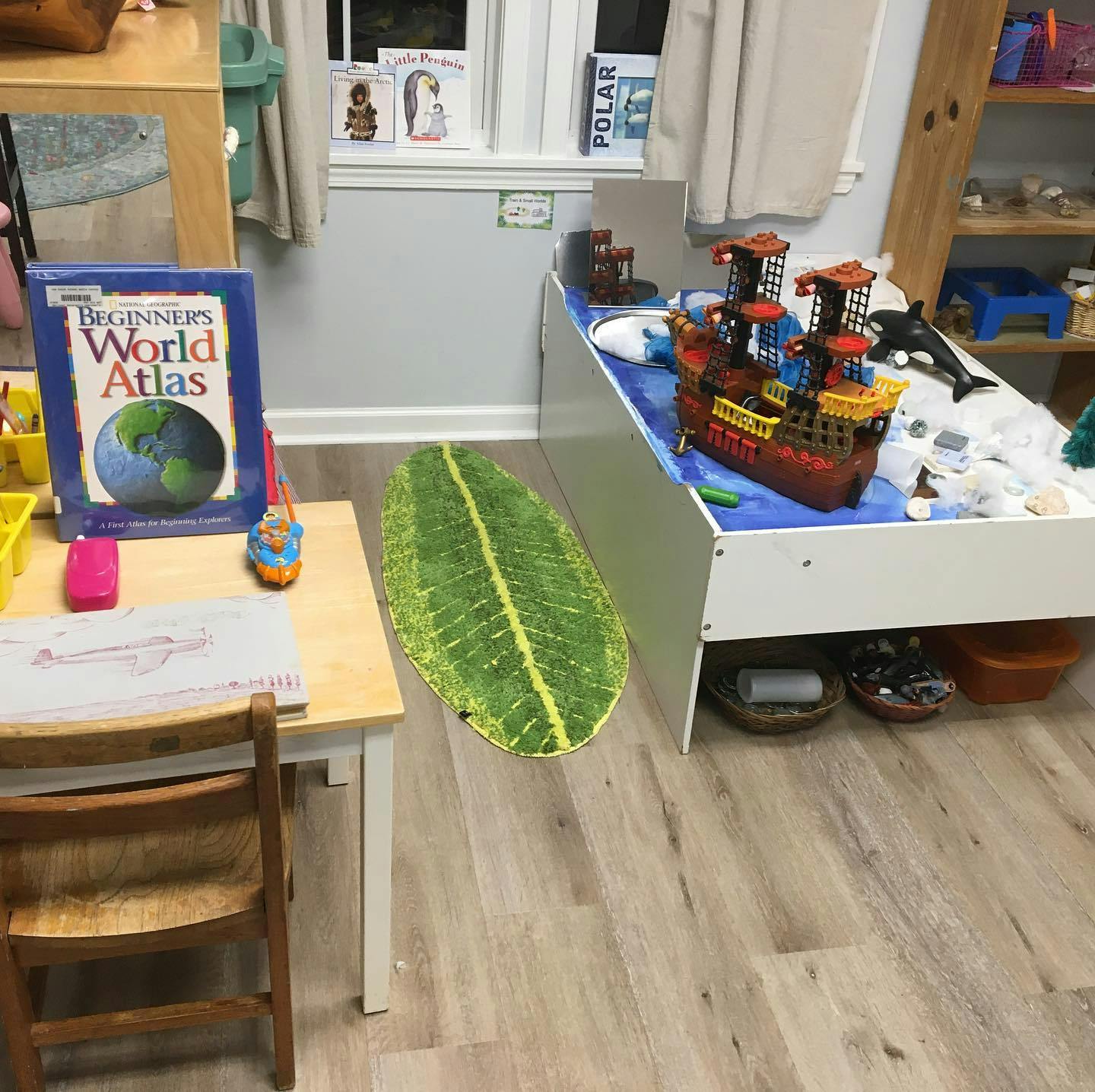 Classroom with a child's table, a book, and a toy pirate ship
