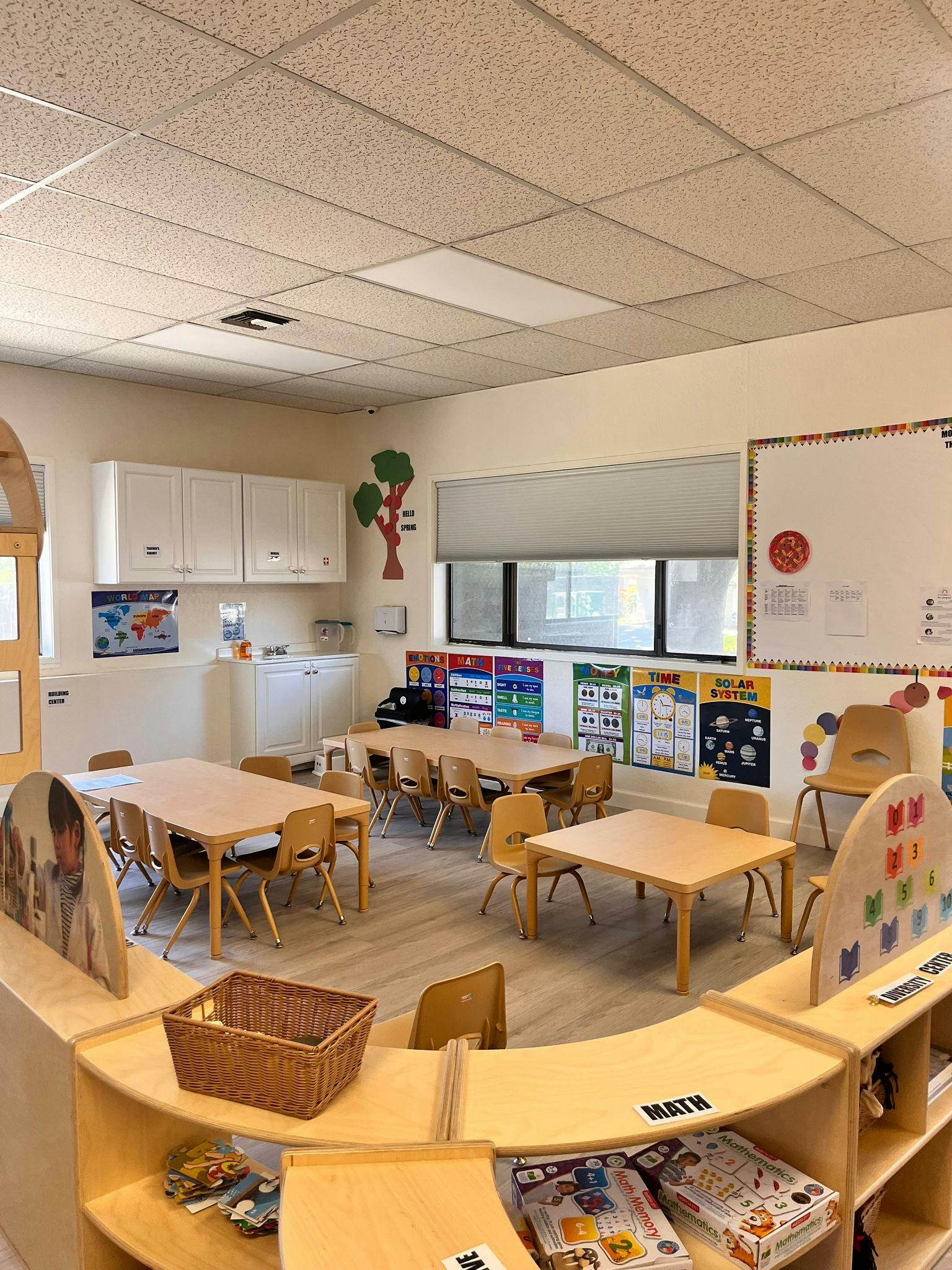 Empty classroom with small tables and chairs