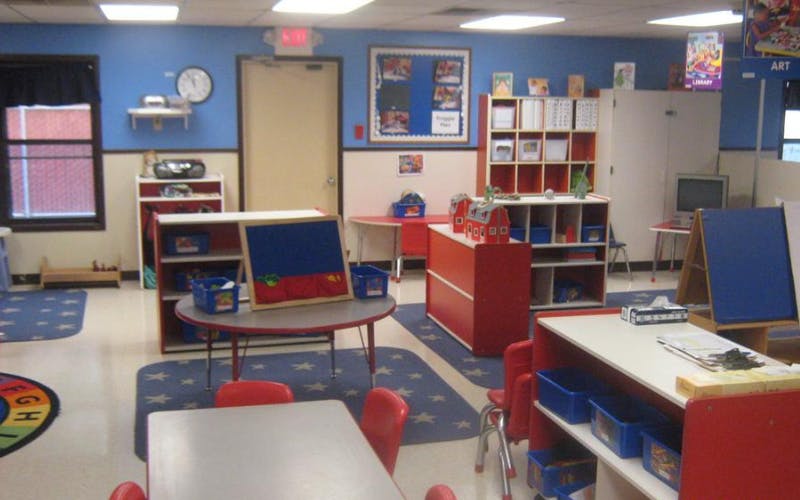 Classroom with small tables, chairs, and learning materials
