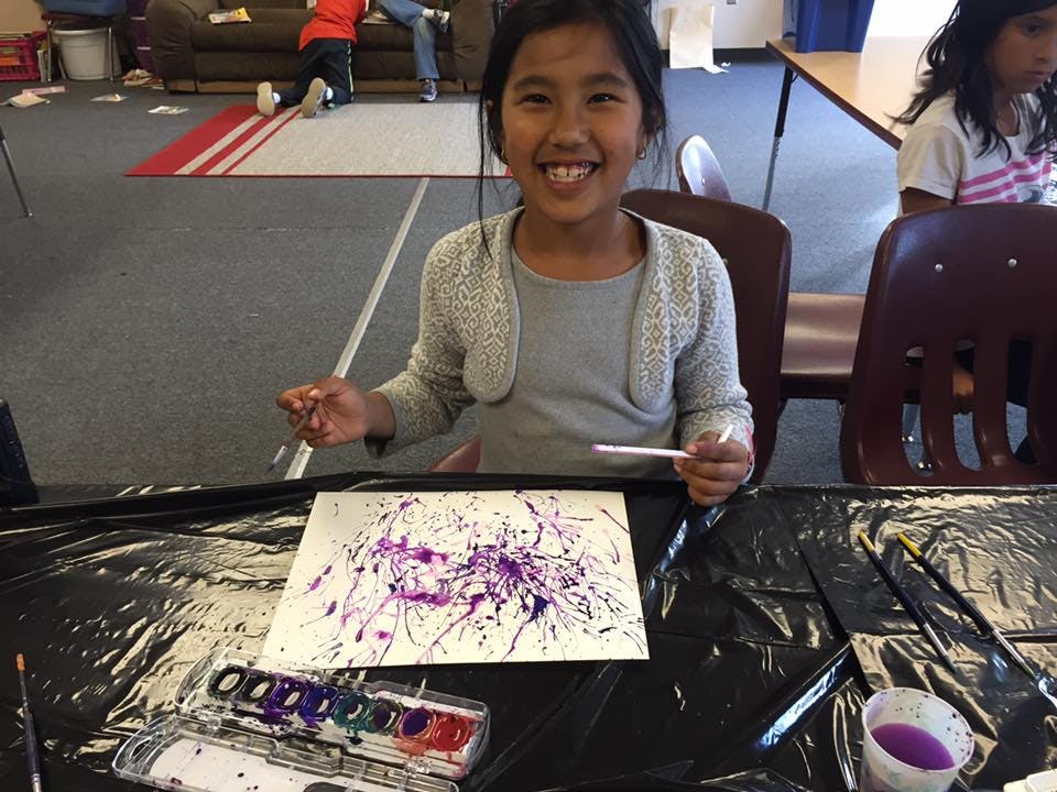 Child painting at a table