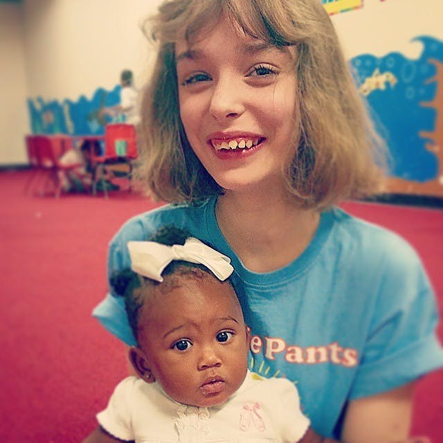 Teen holding a child