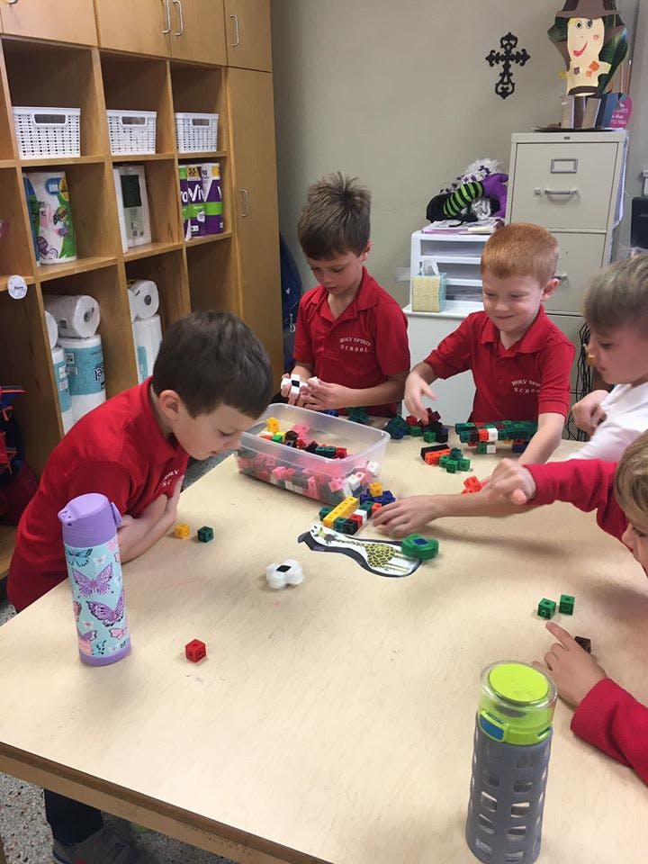 Children playing with building blocks at a table