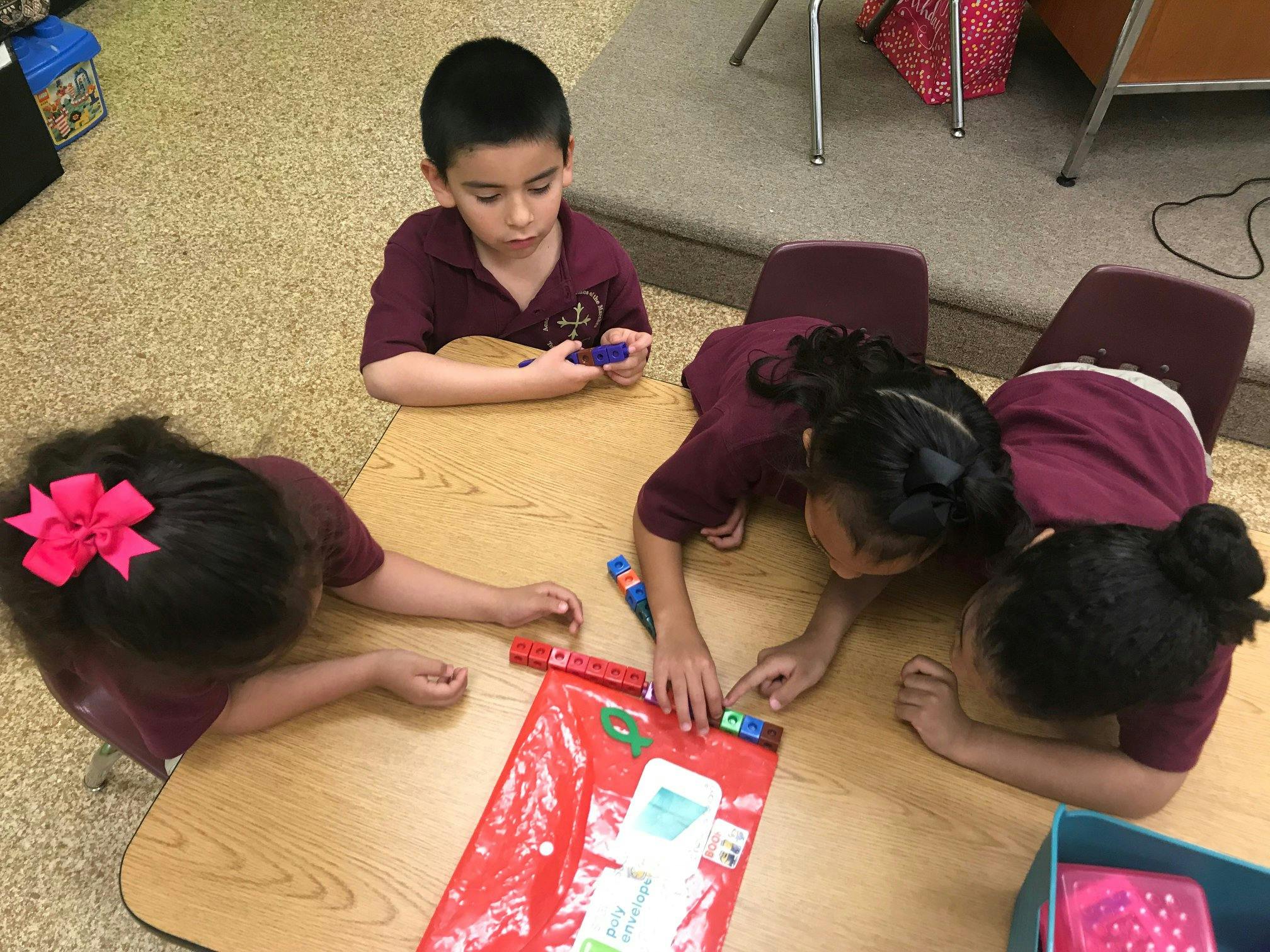 Children working on a project at a table in a classroom