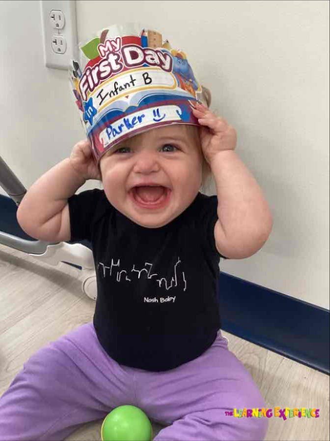 Child wearing a "My First Day" crown