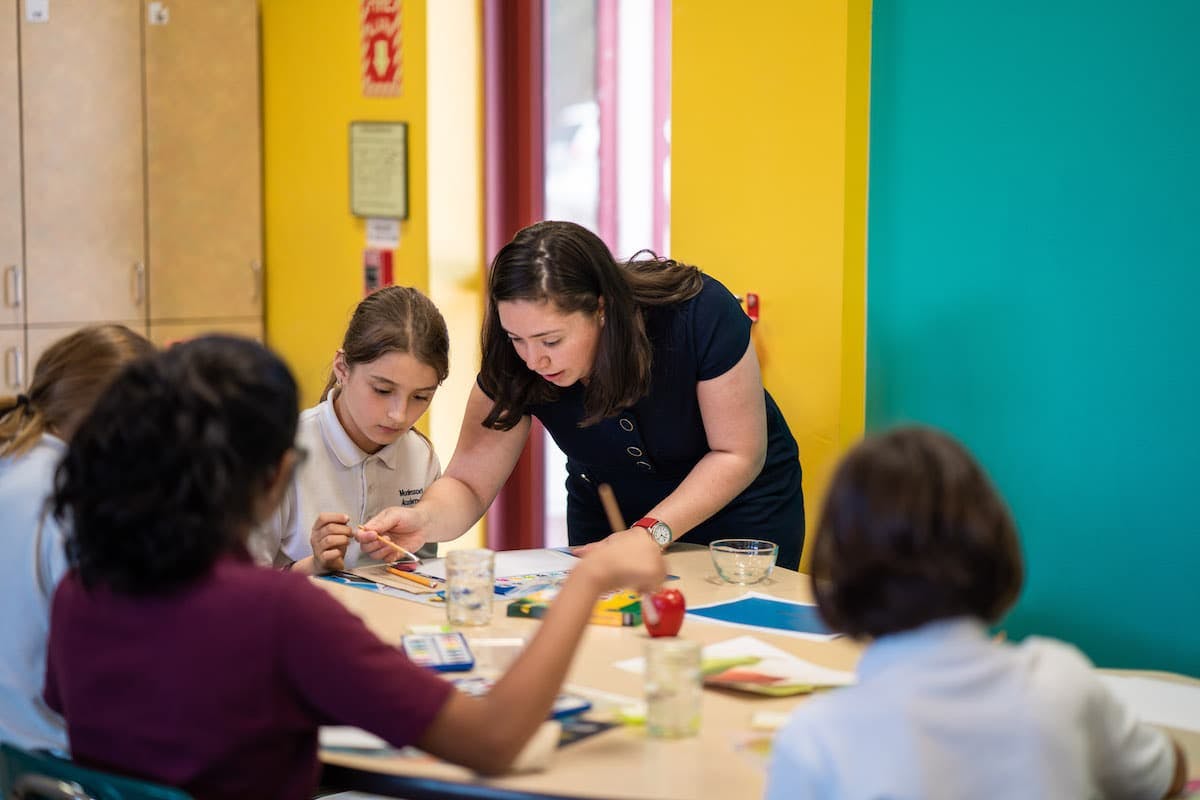 Adult and children at a table in a classroom