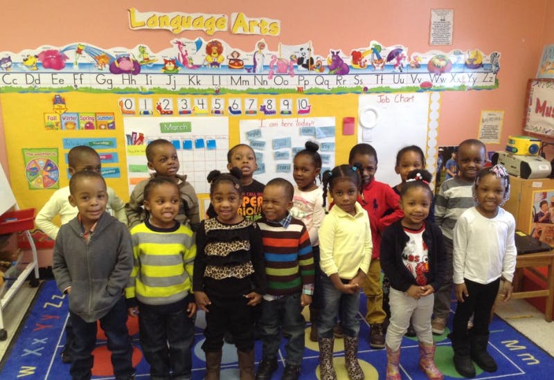 Group of children standing in a classroom