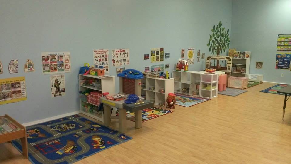 Empty classroom with play mats and shelves