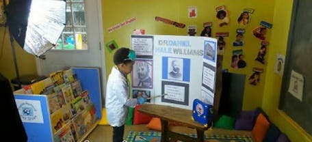 Child looking at a display board about Daniel Hale Williams
