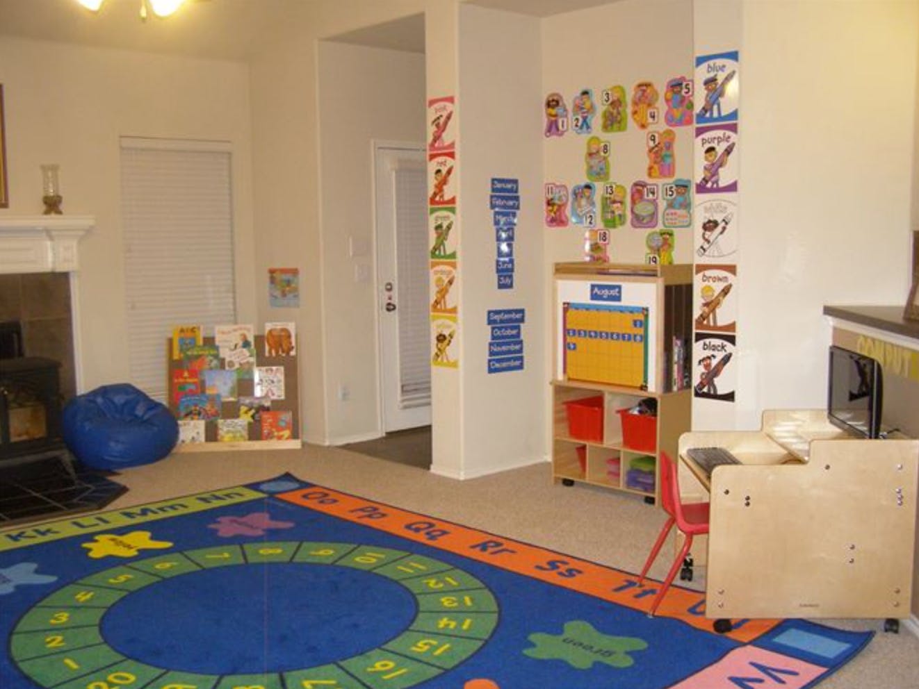 Playroom with a colorful rug, beanbag chair, and educational posters