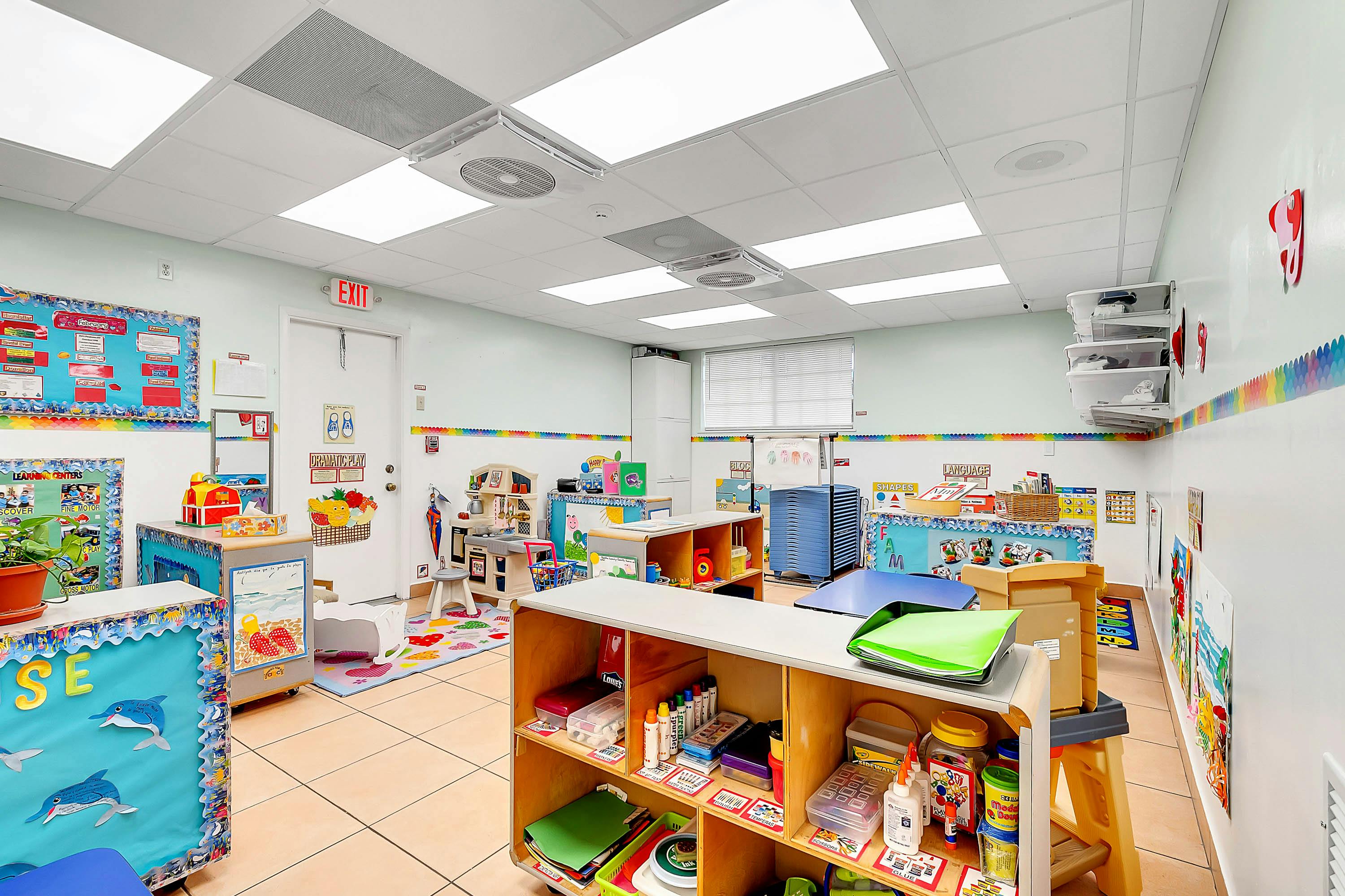 Classroom with shelves, tables, and colorful decorations