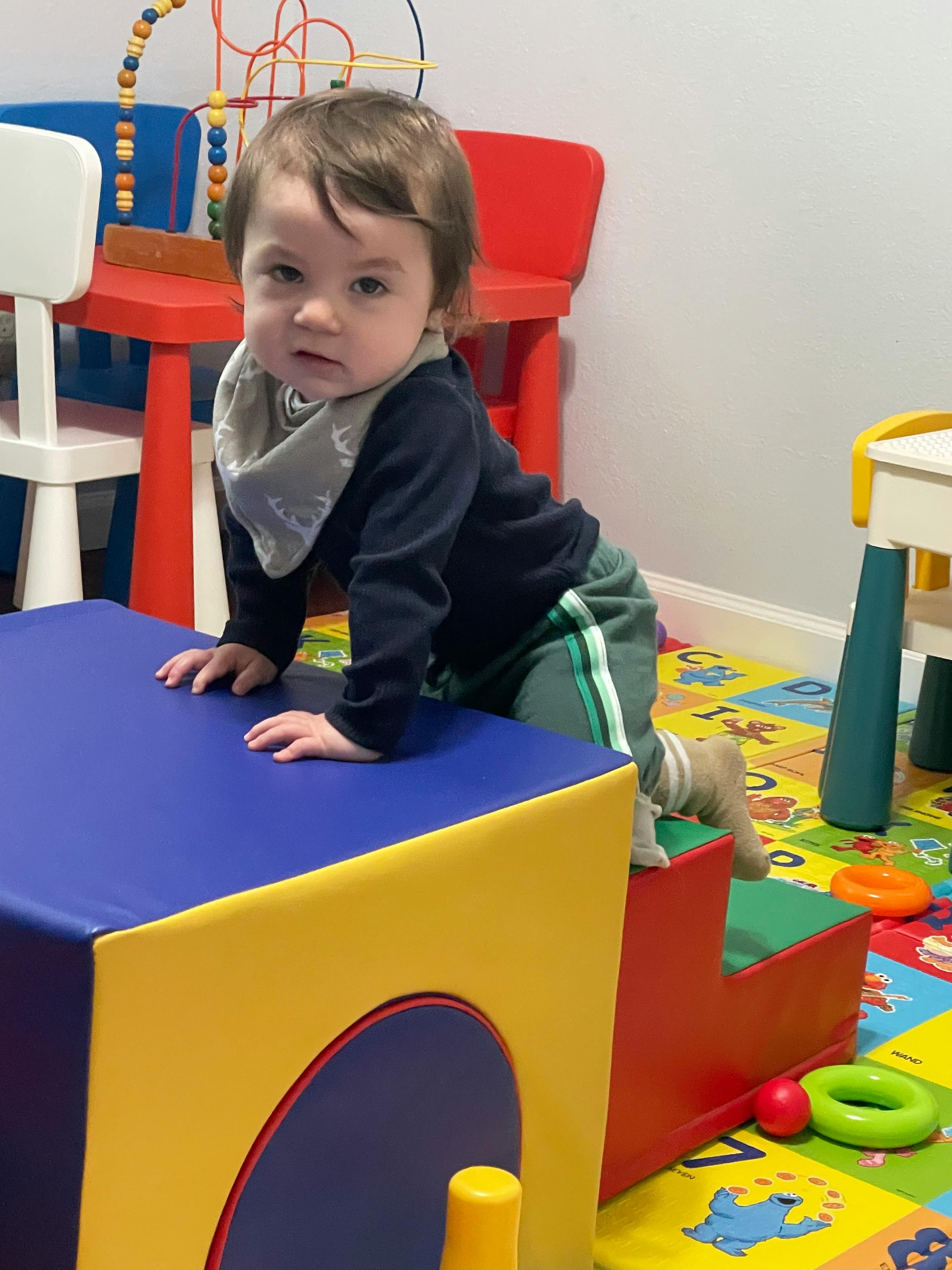 Child crawling on soft play equipment