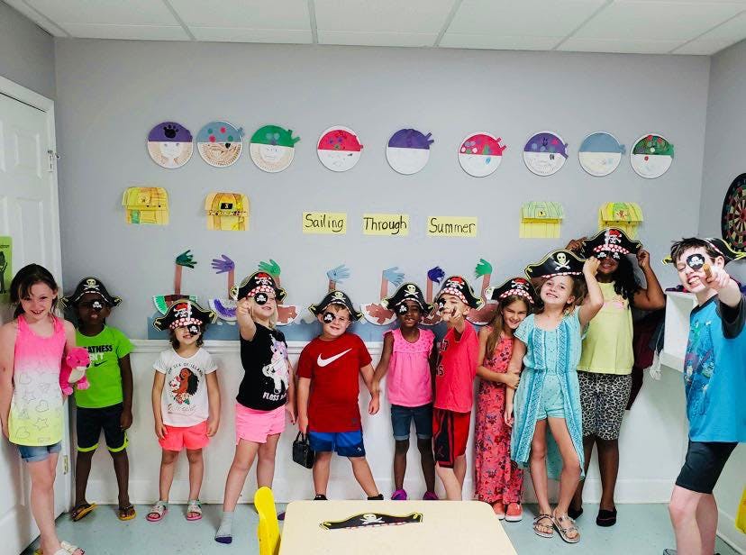 Group of children and adults wearing pirate hats
