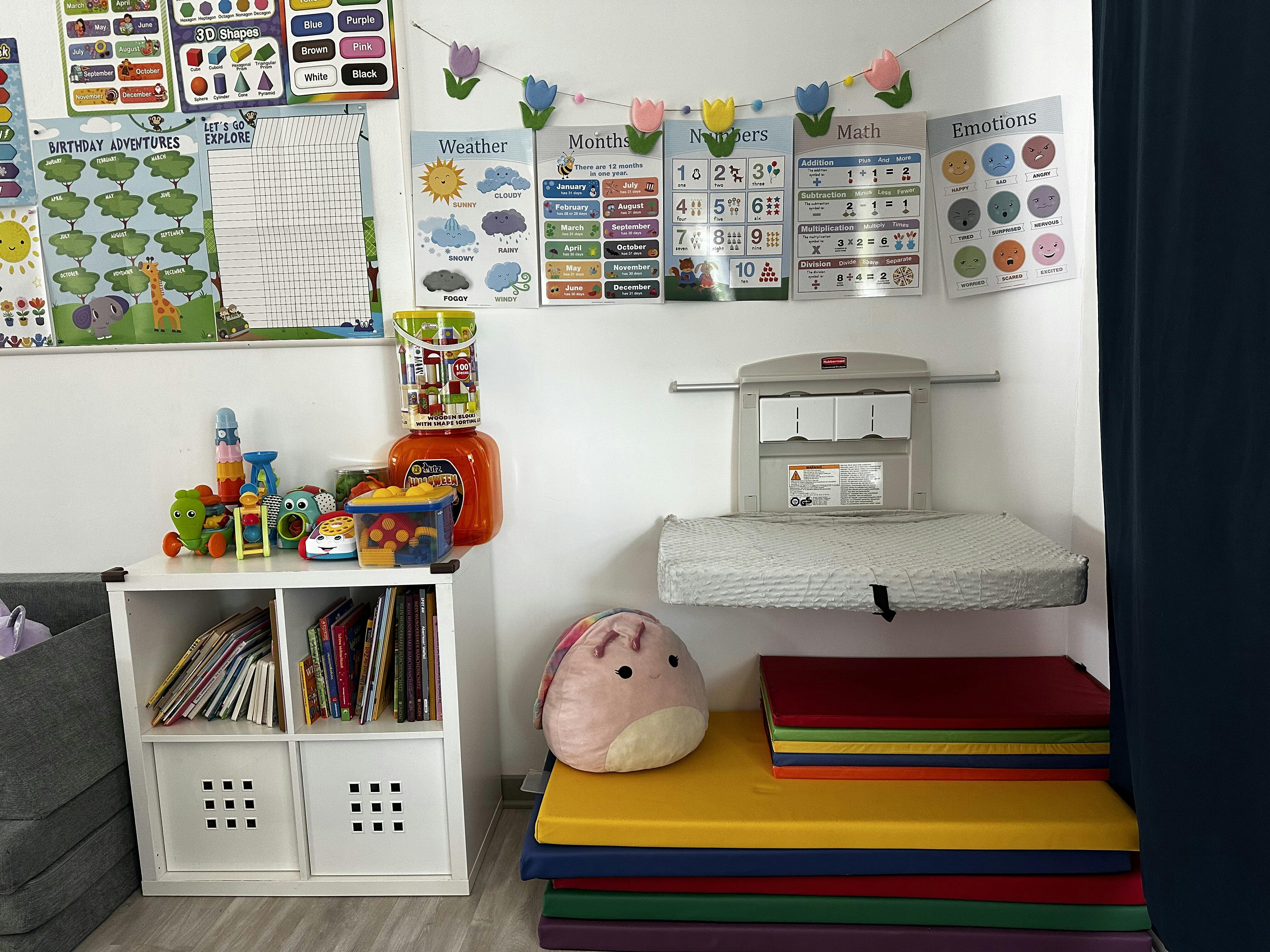 Changing station with colorful mats and educational posters