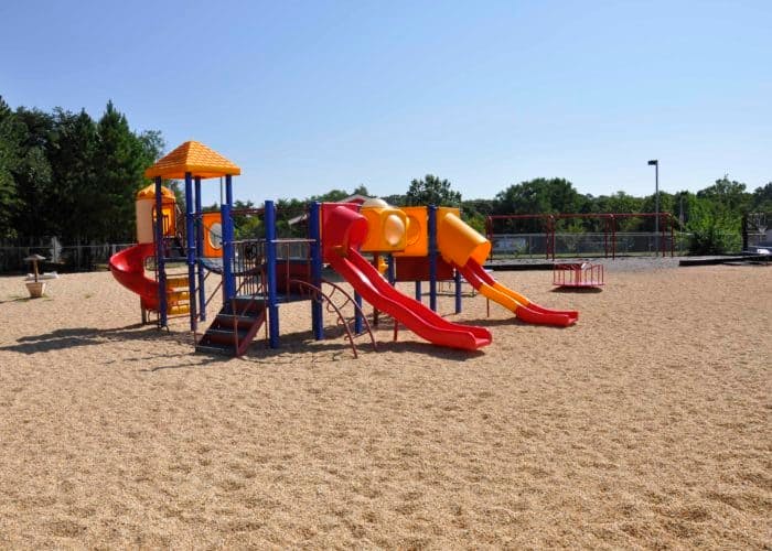 Playground with slides and climbing structures on sand