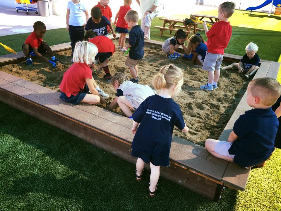 Children playing in a large sandbox
