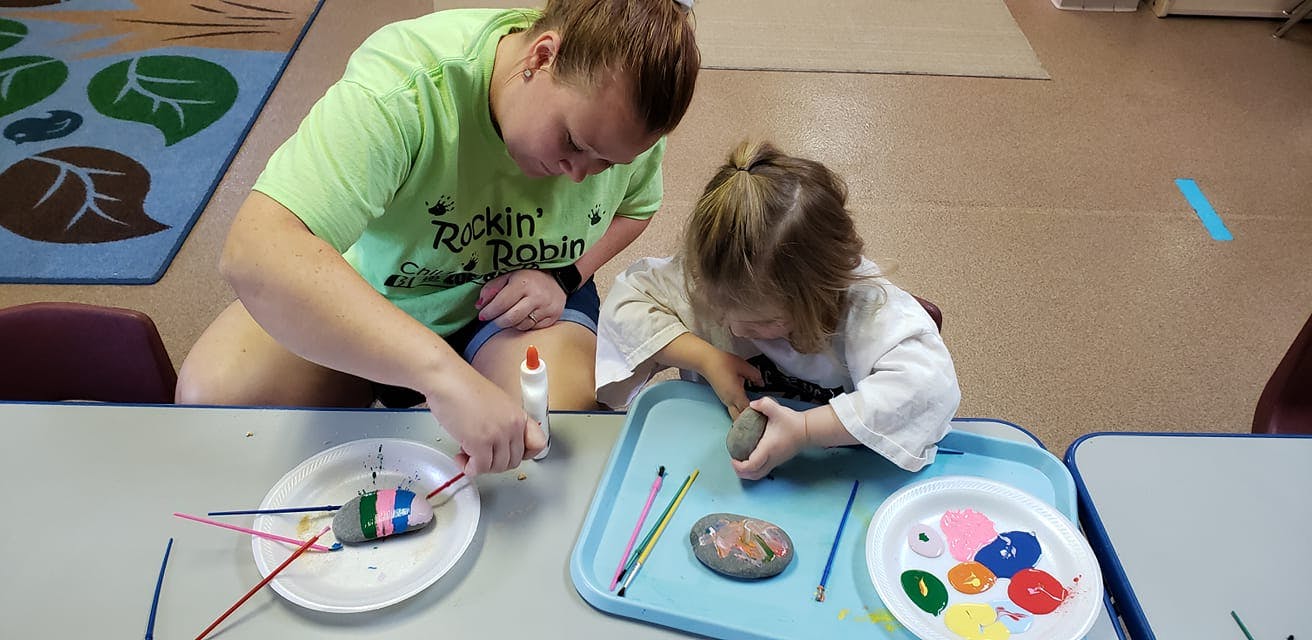 Person and child doing crafts at-table crafts