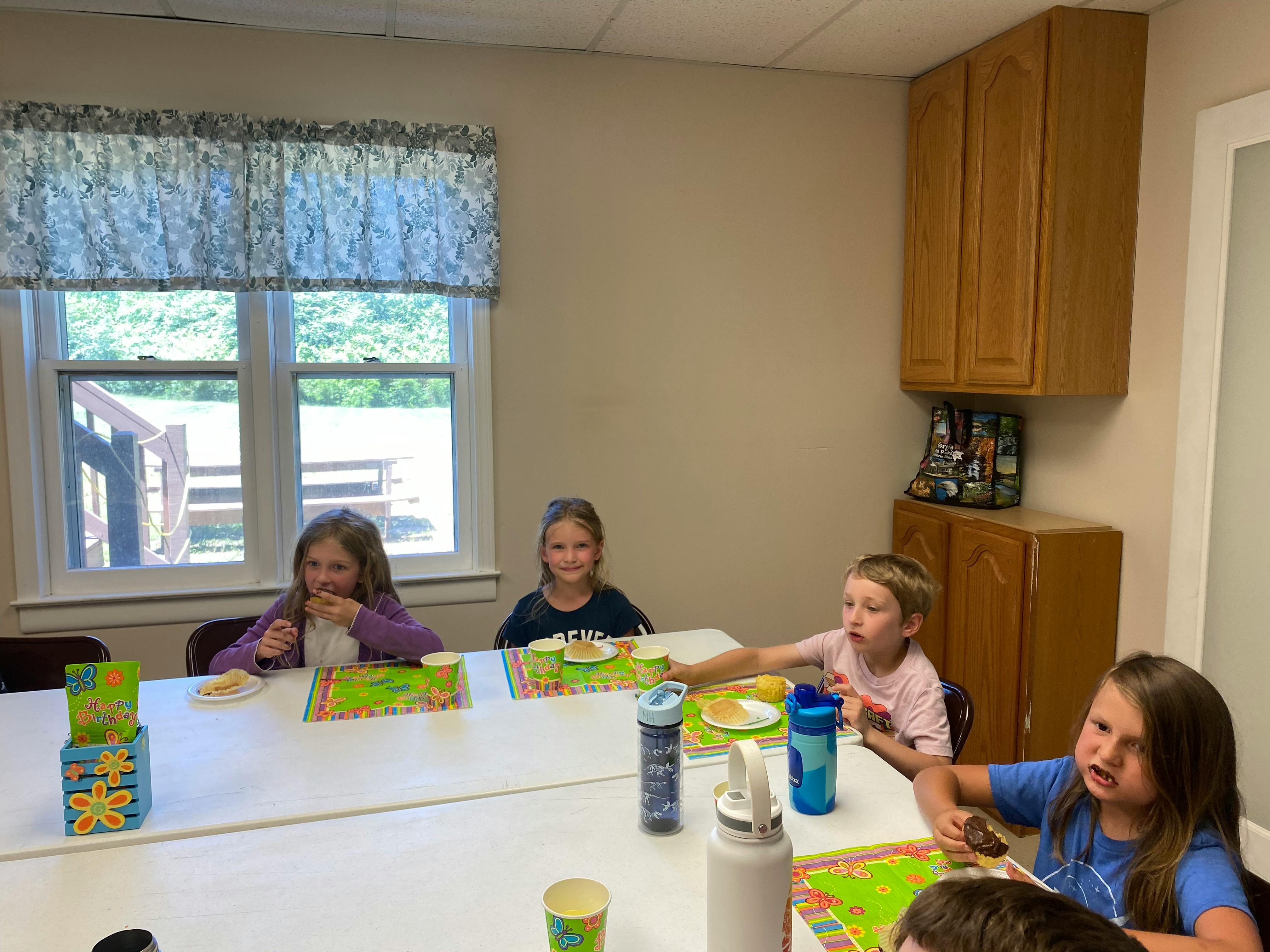 Children sitting at a long table
